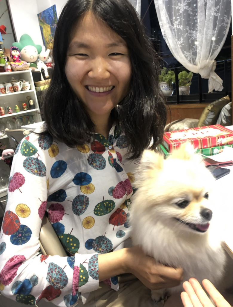 Graduate student smiling with dog