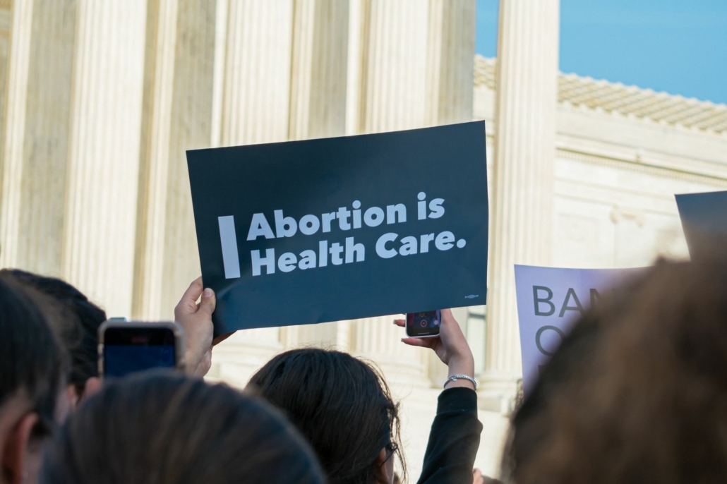 "Abortion is healthcare" sign in a crowd.