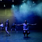 Dancers in dark room.