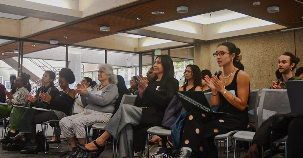 Audience members listen to panel.