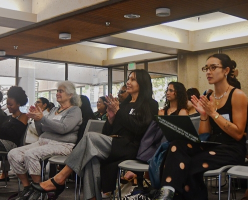 Audience members listen to panel.