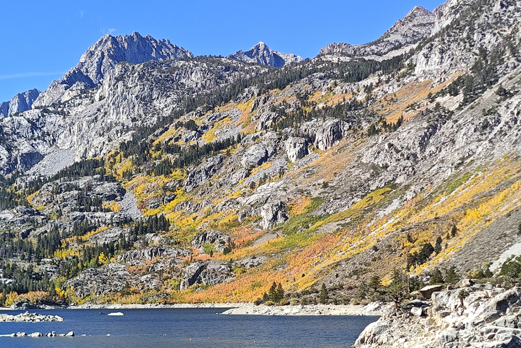 Mountains sloping down into water.